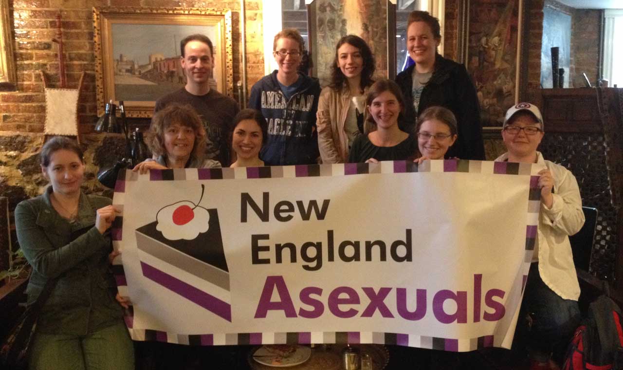 [A picture of some of the New England Aces standing behind our Pride banner]