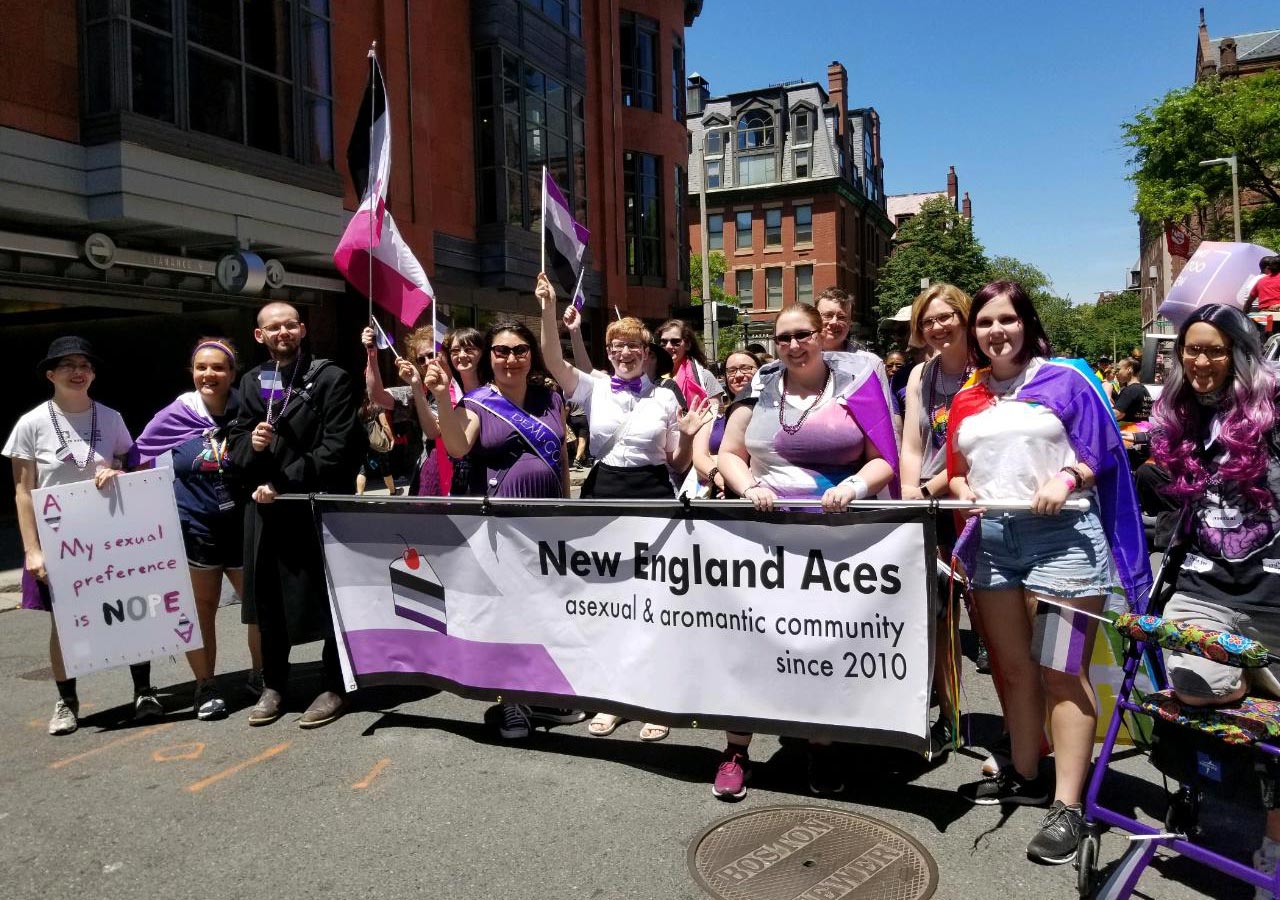 A picture of some of the New England Aces standing behind our Pride banner